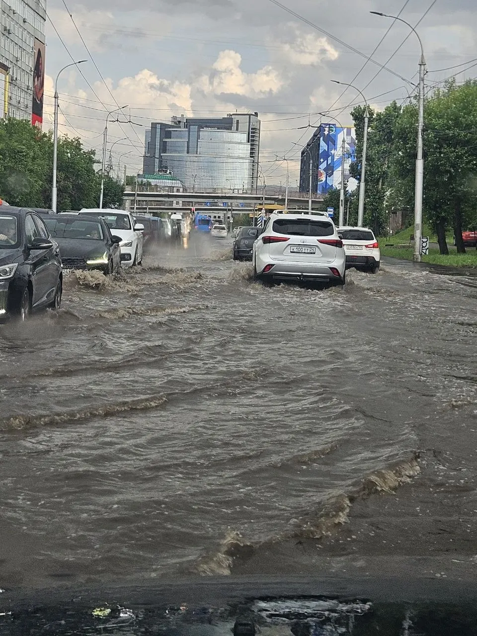 Житель Красноярска прислал фото подтопленной проезжей части на улице Маерчака. В городских службах пояснили, что ливнёвка не успевает сразу принять весь объём воды; ремонт улицы завершили в начале июня.