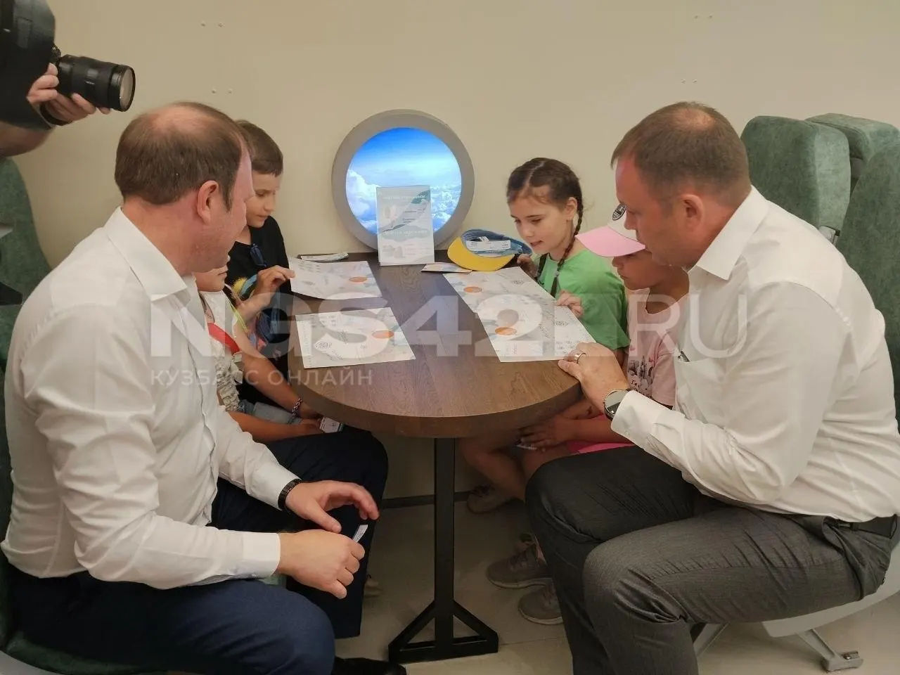 В парке «Антошка» прошло открытие кафе‑самолёта на базе АН‑12: гости пробуют мороженое, среди посетителей — губернатор Илья Середюк и мэр Дмитрий Анисимов.